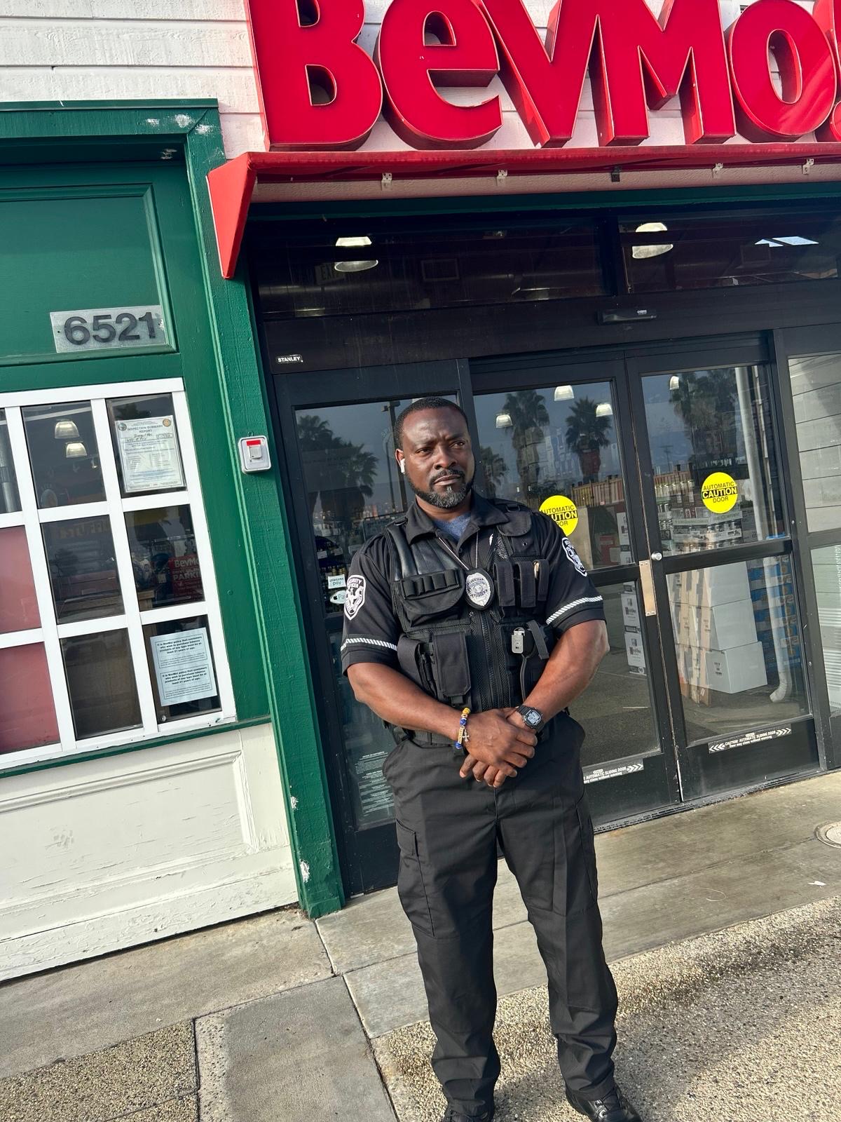 Kamsnotch security officer posted at a retail storefront entrance